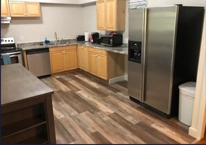 Enjoy cooking in this well-equipped kitchen with a granite countertop, stainless steel appliances, and a dishwasher.