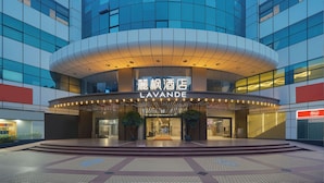 A modern hotel with a curved facade, a prominent entrance, and a sign reading "LAVANDE". - Lavande Hotel Guangzhou Beijing Road Pedestrian Street Haizhu Square Metro Station Branch - Free Deliver Service to Canton Fair Complex During Canton Fair Period (Guangzhou)