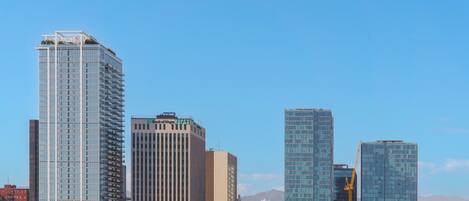 A cityscape with modern high-rise buildings, including a prominent glass-fronted structure.