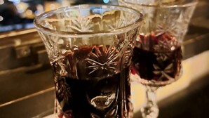 Three glasses with a decorative pattern on a balcony overlooking a cityscape at night. - View of the Old City (Jerusalem)