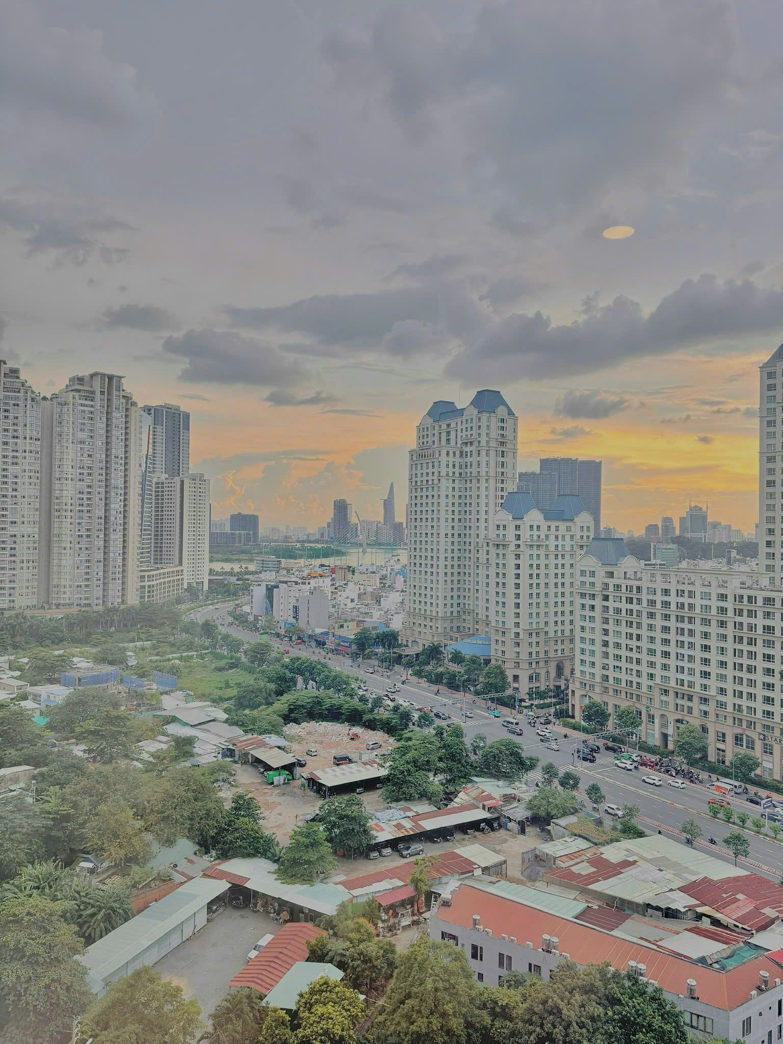 A cityscape with high-rise buildings, a mix of residential and commercial structures, and a clear sky.