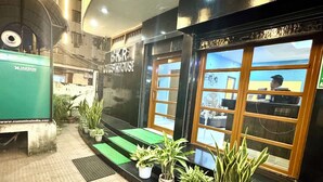 Un edificio con un cartello che recita "BKR WESTHOUSE" e un veicolo verde parcheggiato davanti.