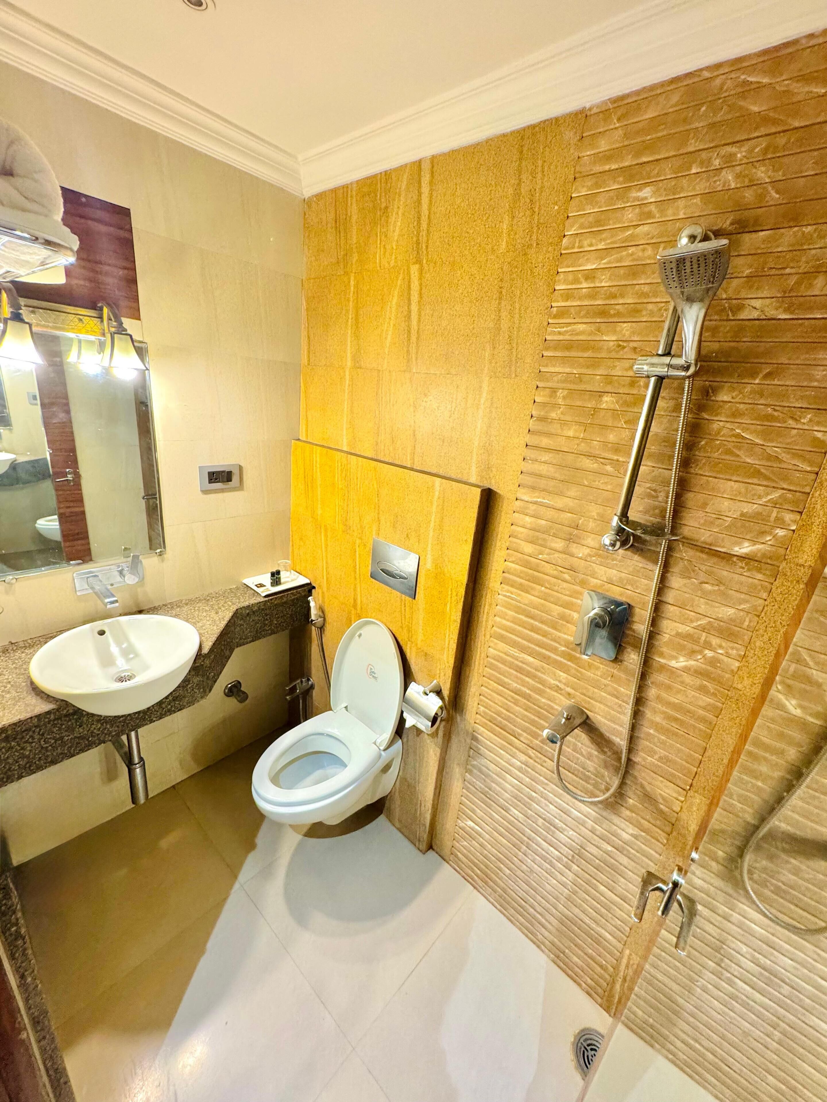 A modern bathroom with a sink, toilet, and shower.