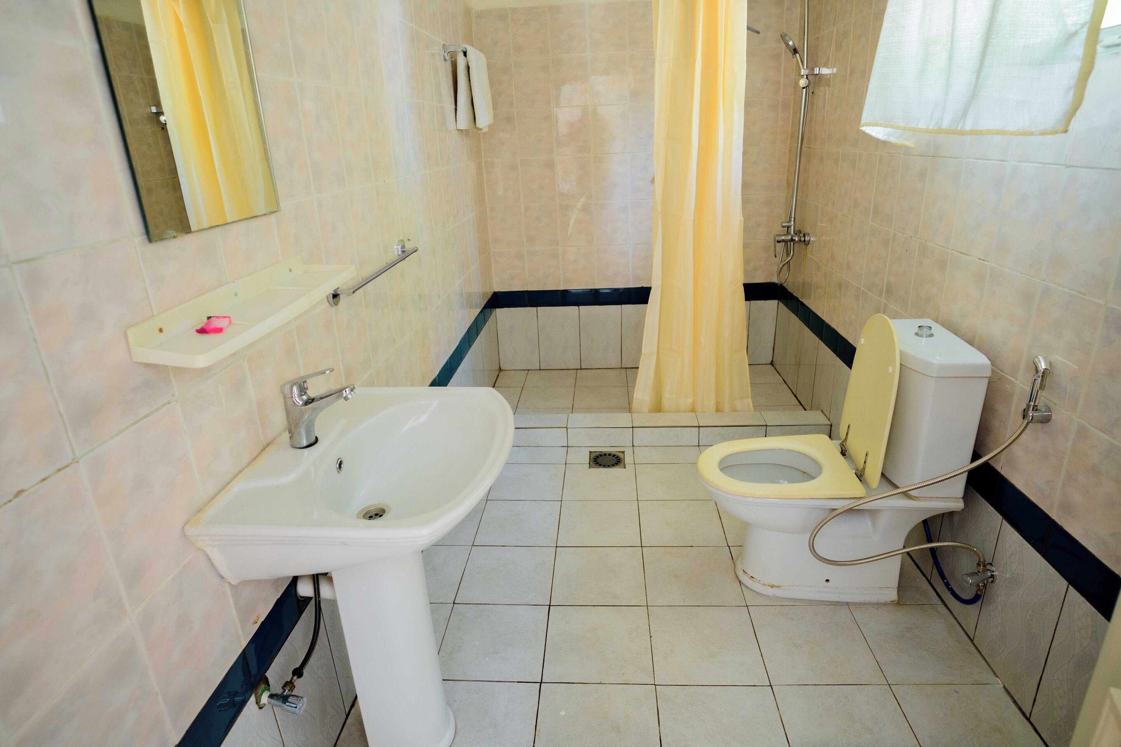 A bathroom with a sink, toilet, and shower.