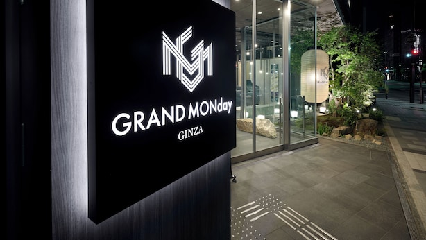 A nighttime view of a building entrance with a sign reading "GRAND MONDAY CINZA". - GRAND MONday GINZA (Tokyo)