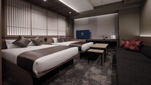 A modern hotel room with two beds, a sofa, a small table, and a TV. - GRAND MONday GINZA (Tokyo)