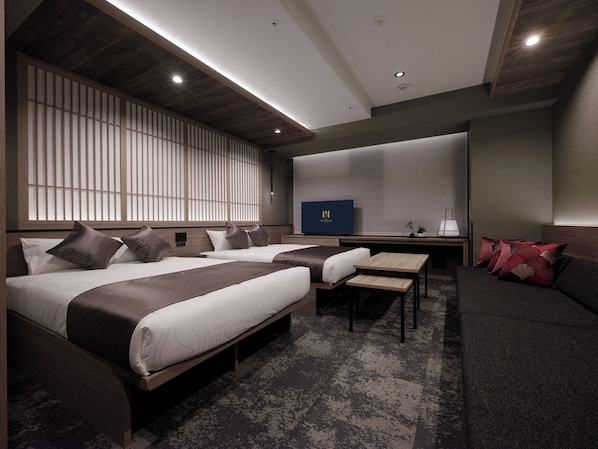 A modern hotel room with two beds, a sofa, a small table, and a TV. - GRAND MONday GINZA (Tokyo)