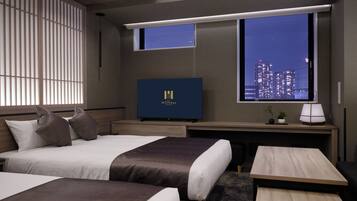 A hotel room with two beds, a desk, a television, and a window with a city view.