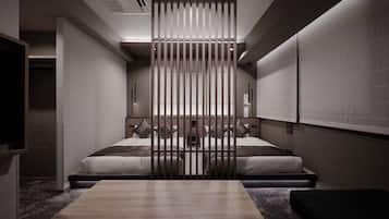 A modern hotel room with a bed, a desk, and a partition wall.