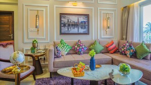 A well-decorated living room with a sofa, coffee table, and a framed cityscape picture. - Alaya Stays Veera Marina 2BHK (Candolim)