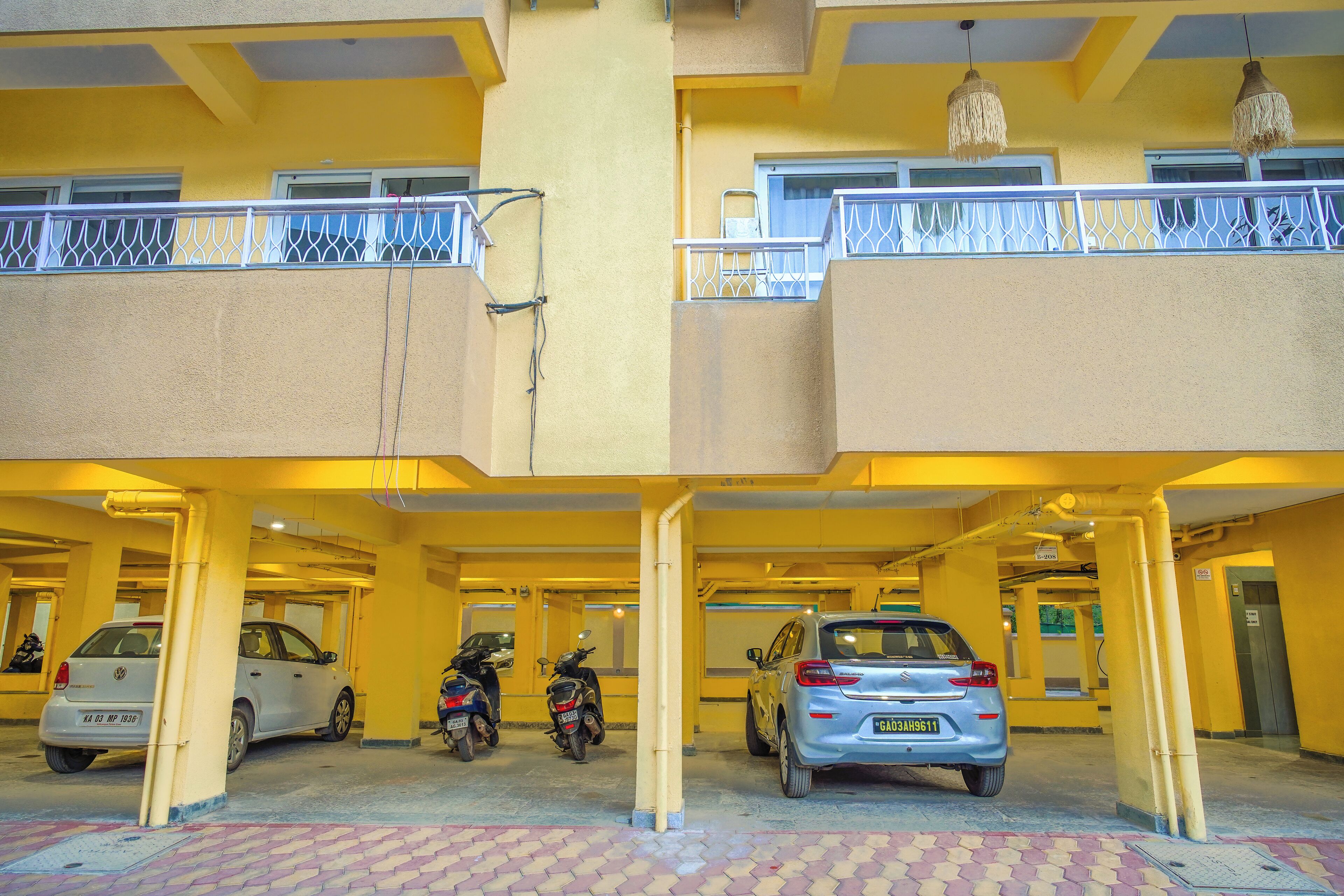 A multi-level parking garage with cars and motorcycles parked.