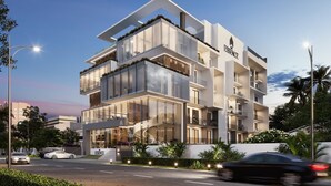 A modern multi-story building with a prominent 'ESSENCE' sign, large glass windows, and balconies with plants. - Quao Realty - The Essence (Accra)
