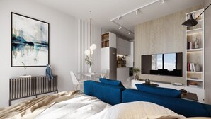 A modern bedroom with a large bed, a blue sofa, a TV, and a bookshelf. - Quao Realty - The Essence (Accra)