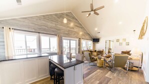 A spacious kitchen with a large island, bar stools, and a ceiling fan. - Ocean "Front" Lux, 3 Living Rooms: SeaView House (Crescent city)