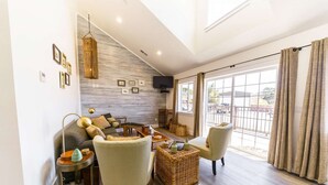 A spacious living room with a sofa, armchairs, a coffee table, and a TV mounted on the wall. - Ocean "Front" Lux, 3 Living Rooms: SeaView House (Crescent city)