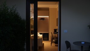A hotel room with a bed, bedside table, and a small table with a chair. - Residenza Gurnea - Free Private Parking (Tropea)