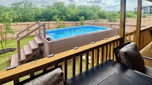 A backyard with a swimming pool, wooden deck, and outdoor seating area. - 6 Mi to Lackland Afb: Hot Tub, Pool & Game Room! (San Antonio)