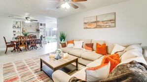A living room with a sofa, coffee table, and a dining area with chairs and a table. - 5 Mi to Museum of the Great Plains: Home w/ Patio (Lawton)