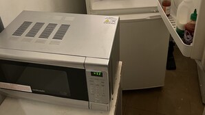 A compact kitchen with a built-in microwave, a refrigerator, and a sink. - 1 double room in London with WiFi (London)