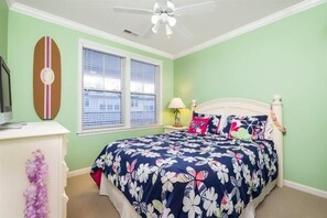 A bedroom with a bed, a nightstand, a lamp, a ceiling fan, and a window with blinds. - Sunset Island - 39 Fountain Drive West 3f 3 Bedroom Condo (Ocean City)