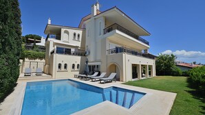 A large, two-story house with a swimming pool, outdoor seating, and a well-maintained lawn. - VILLA DOMUS RIVIERA with exclusive pool and breathtaking panoramic views (Voula)