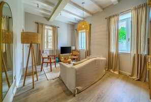 Luxury Suite, City View | Living area | 48-inch Smart TV with digital channels