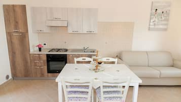 Fridge, stovetop, cookware/dishes/utensils, dining tables