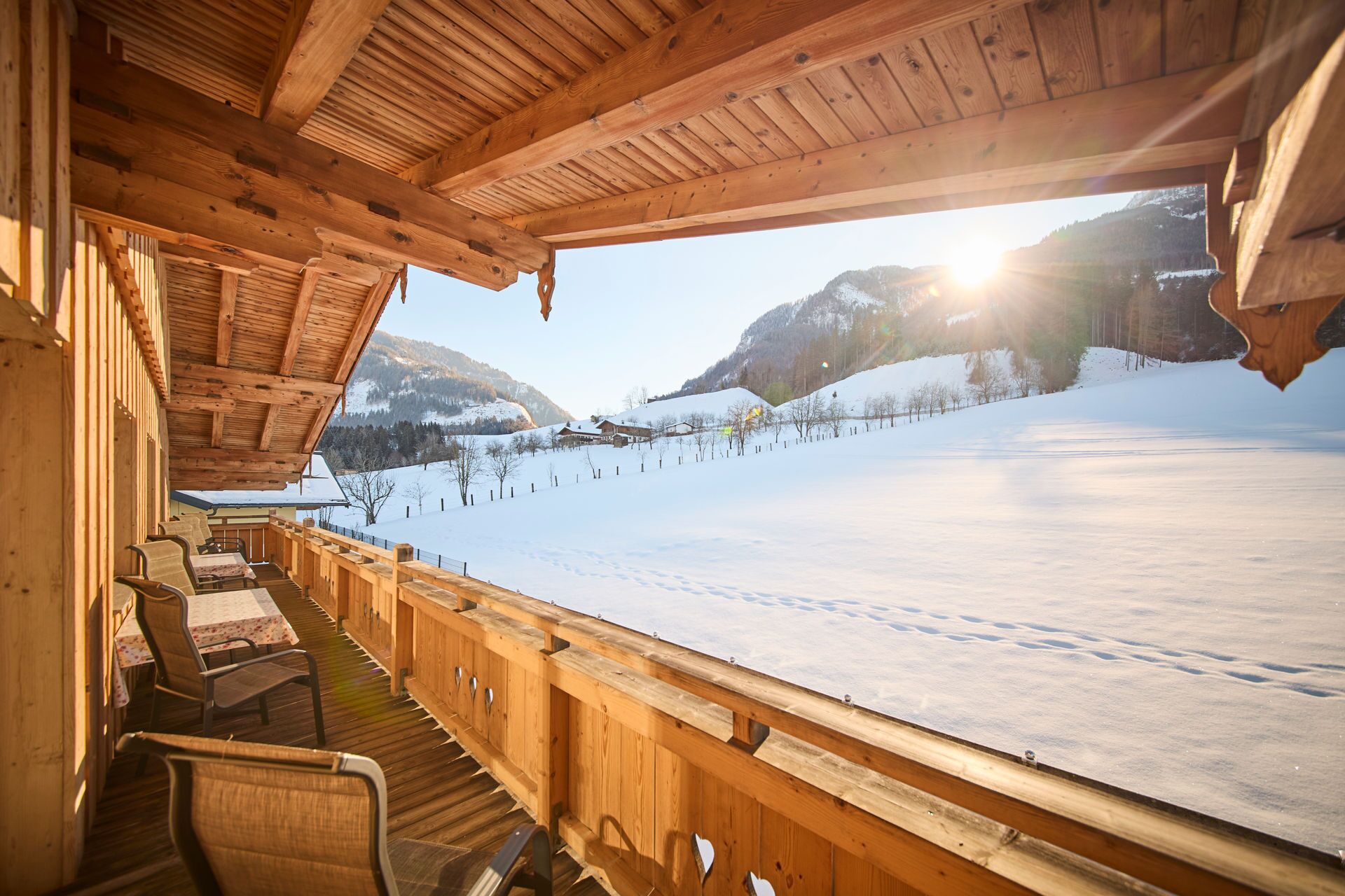 Une cabane en bois offrant une vue sur un paysage enneigé et des montagnes.