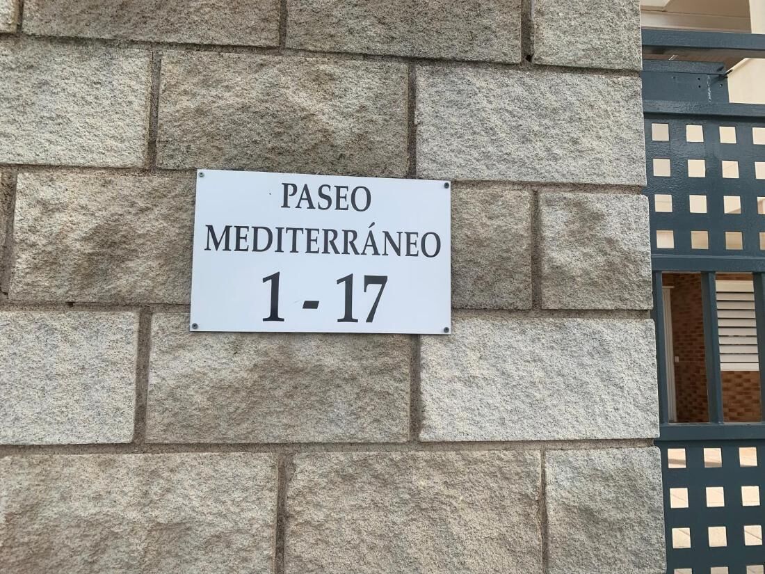 Un letrero en una pared de piedra que indica 'PASEO MEDITERRÁNEO 1-17'.
