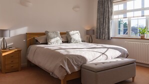 A bedroom with a bed, bedside tables, a window with curtains, and a radiator. - Seas the Day, Broadstairs (Broadstairs)