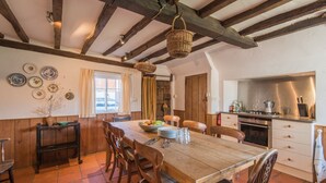 A rustic dining area with a wooden table, chairs, and a hanging basket. - Bell House, Wickhambreaux (Wickhambreaux)