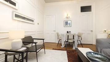 Family Apartment, City View | Living area | 24-inch flat-screen TV with cable channels