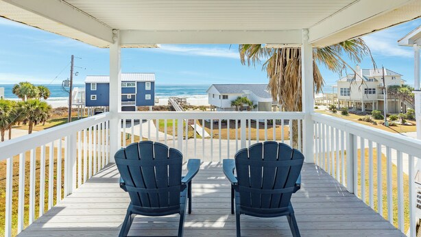 A covered deck with two Adirondack chairs facing a beach view. - 2nd Row Gulf Views, 3 Decks, Beach Equipment/Toys, Steps from the Beach! (Galveston)
