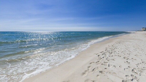 A beach with clear skies and calm waters. - La Madeleine Coastal Home Resort Pools Quiet Beach (Gulf Shores)