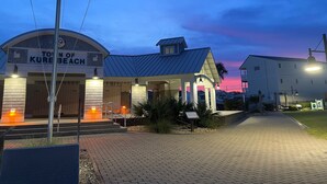 A building with a sign reading 'Town of Kure Beach' and a flagpole with flags. - Gorgeous 4 BR with Ocean Views & Pool (Kure Beach)