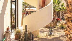 A modern house with a spiral staircase leading to a balcony. - Sunny Bungalow with a Pool and Near the Beach (El Pescadero)