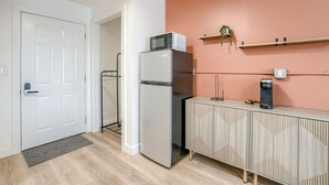 A compact kitchen with a refrigerator, microwave, and a coffee machine on a wooden cabinet. - 5 min. to Lincoln's top attractions. 2 Queens, WiFi, pickleball, & outdoor space (Lincoln)