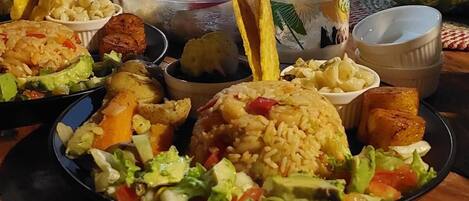 A table with various dishes including rice, vegetables, and fried items.