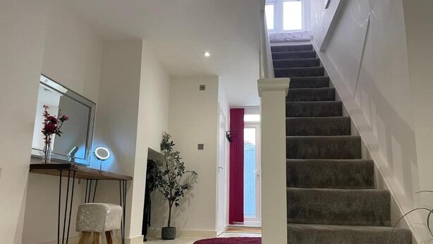 A modern interior with a staircase, a vanity with a mirror, and a potted plant. - Spacious1br-6guests-walktoshops-fastwifi (Royal Tunbridge Wells)