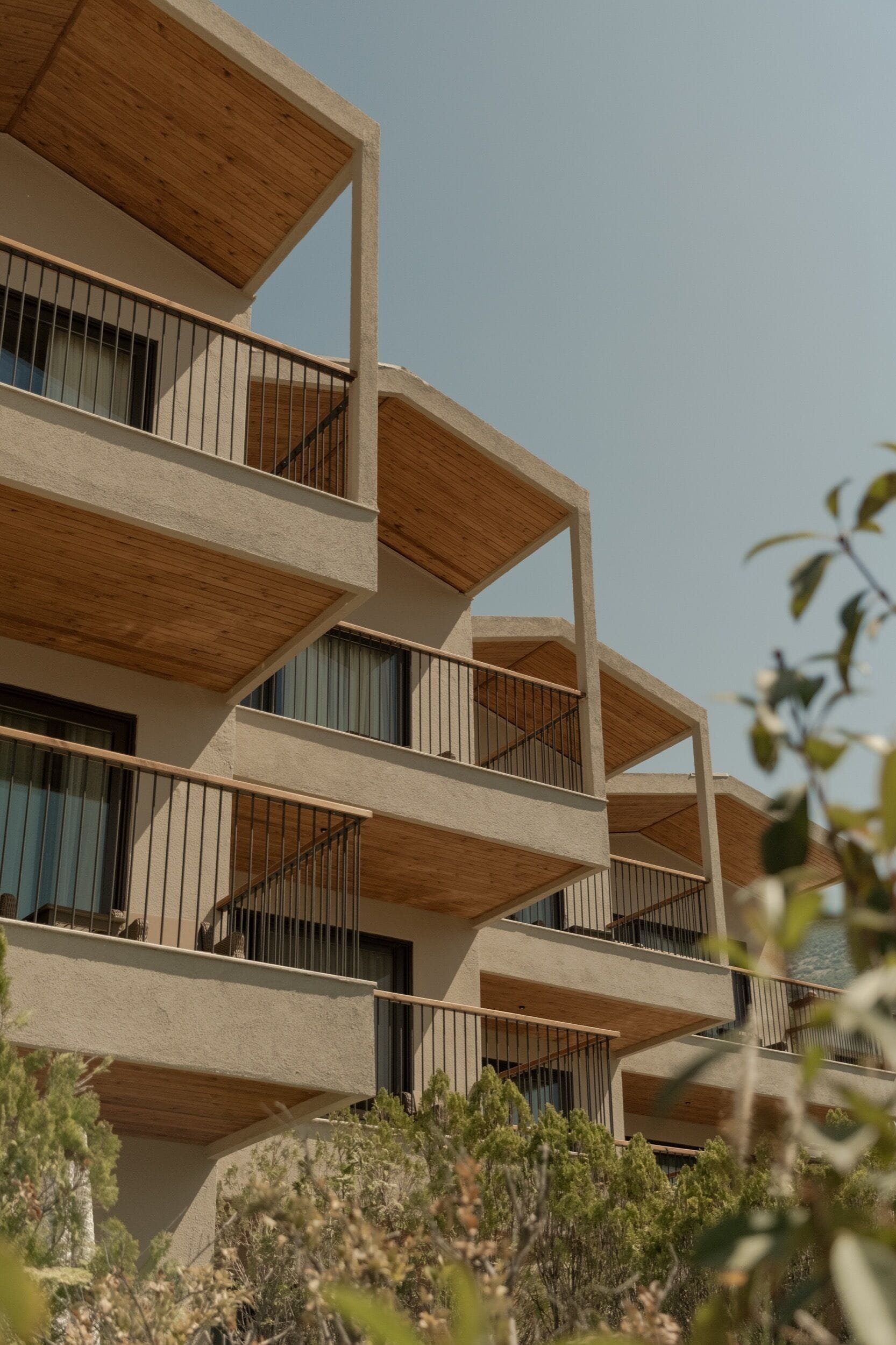 A multi-story building with balconies and a clear sky.