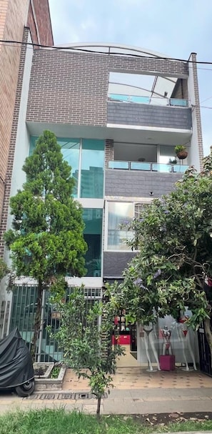 A modern two-story building with large windows and a balcony. - AMOBLADO LOS MOLINOS (Medellín)