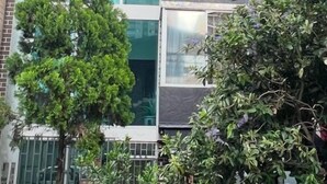 A modern two-story building with large windows and a balcony. - AMOBLADO LOS MOLINOS (Medellín)
