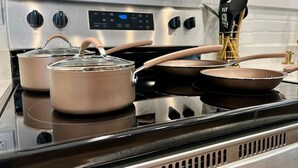 A stainless steel stove with pots and pans on it.