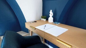 Una moderna scrivania da ufficio con un quaderno, una penna e oggetti decorativi.