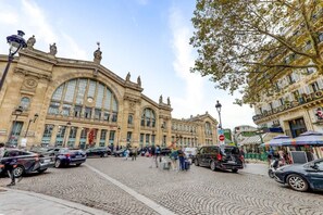 A historic building with large arched windows and classical architecture.