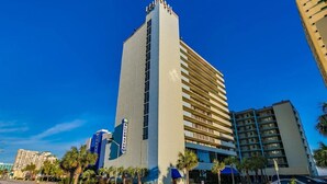 A hotel with a tall, rectangular structure, multiple floors, and a prominent sign. - Bluewater Resort 1106 (Myrtle Beach)