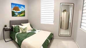 Une chambre à coucher avec un lit, une table de chevet, un miroir et un tableau accroché au mur.