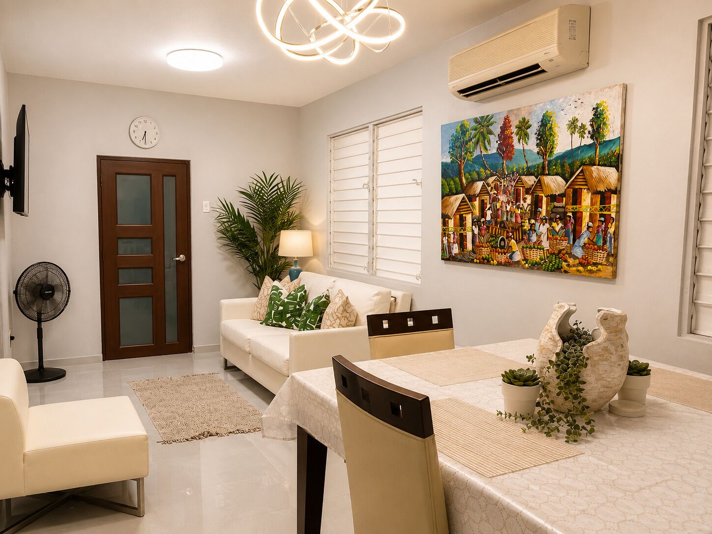 A modern living room with a dining area, a clock, an air conditioner, and a painting on the wall.