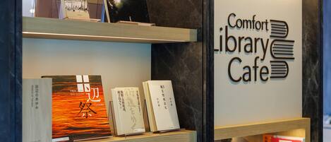 A library cafe with bookshelves and a sign reading "Comfort Library Cafe".