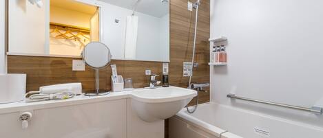 A modern bathroom with a white sink, mirror, and bathtub. There are toiletries on the wall and a towel rack above the sink.